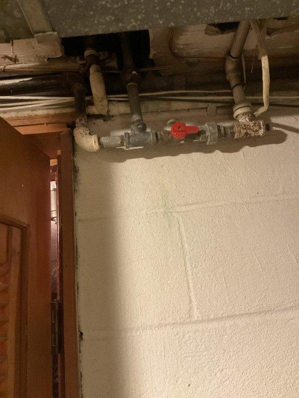 Installed new gas line in basement utility area to supply residential kitchen stove. Ran copper piping through exposed ceiling joists with proper fittings and connections, including shutoff valve for safety compliance. Line was routed from existing gas supply through unfinished basement space to kitchen appliance location, with all connections pressure-tested and verified for leak-free operation.