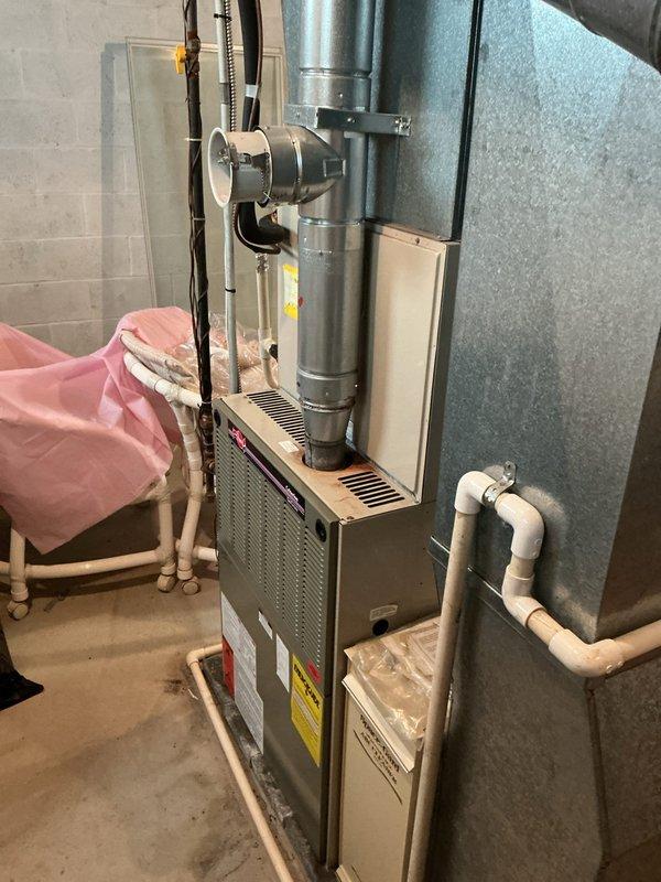 Completed comprehensive estimate for furnace and air conditioning replacement system. Assessed existing HVAC installation including vertical furnace unit with galvanized ductwork, metal flue piping, and PVC condensate drainage system in basement utility area. Customer qualified for promotional pricing on air conditioning equipment replacement.