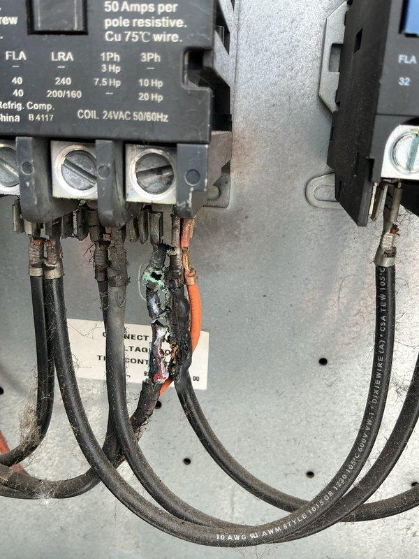 Responded to no cooling call for commercial rooftop HVAC unit. Upon inspection, discovered severely deteriorated wiring at contactor with extensive insulation breakdown, exposed conductors, and green corrosion buildup on copper wiring. The damaged wiring posed both a safety hazard and was preventing proper unit operation. Documented existing conditions with photos showing the corroded connections and compromised wire insulation at the 50-amp contactor terminals. Advised that immediate electrical repairs are required to restore cooling function and ensure safe operation of the system.