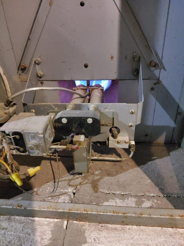 Performed comprehensive tune-up and inspection on two basement boilers—a 60-year-old unit and a 40-year-old unit—both operating normally at time of service. Conducted full system diagnostics including combustion analysis, burner inspection, gas valve operation verification, and safety control testing on both units. Verified proper flame characteristics with blue ignition pattern present, confirmed gas line connections and fittings secure, and inspected electrical wiring and control systems for both boilers. Cleaned burner assemblies, checked for carbon buildup, and ensured proper venting. Inspected one radiator exhibiting rust deterioration and documented condition for follow-up. All safety controls tested and functioning within manufacturer specifications. Both boilers returned to service with normal operating parameters confirmed.