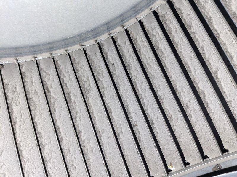 Completed routine cooling system maintenance tune-up on residential HVAC unit. Upon arrival, discovered significant frost accumulation on evaporator coil fins, indicating restricted airflow or potential refrigerant issue. Documented system operating temperature of 71.0°F at outdoor unit location. Performed comprehensive inspection of condenser unit, noting dust and debris buildup on exterior panels and surrounding components. Addressed frost condition by identifying underlying cause, checked refrigerant charge levels, and verified proper system operation. Cleaned accessible components and ensured unit returned to normal operating parameters before departure.