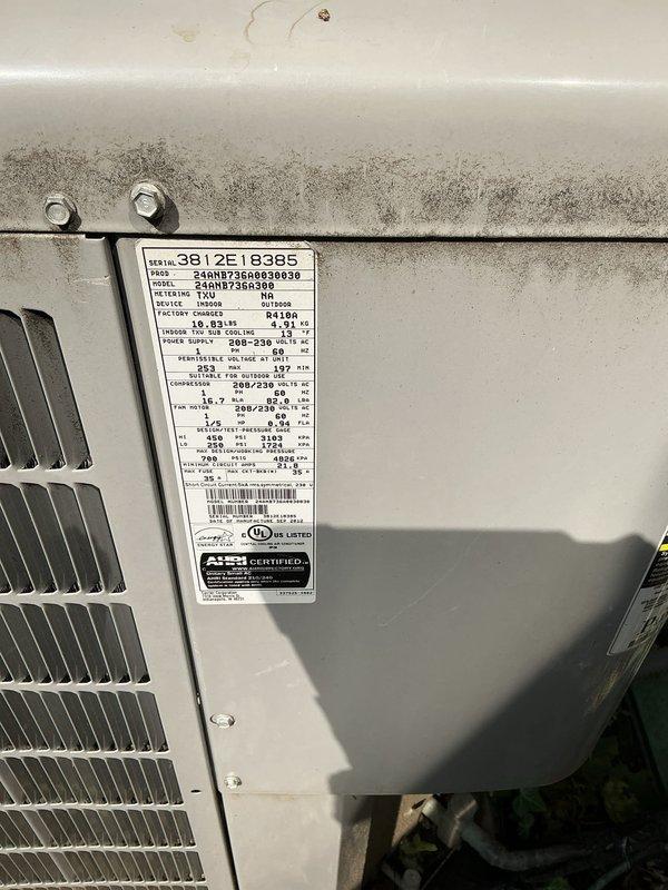 Conducted comprehensive evaluation of existing HVAC system for replacement estimate. Assessed outdoor condensing unit displaying weathering and dirt accumulation, documented model 3812E18385 with serial number 24HN873G, verified TXV metering device and electrical specifications, confirmed AHRI certification. Inspected indoor furnace installation in basement mechanical room, evaluated vertical furnace unit with PVC venting system, examined adjacent air handling equipment with associated refrigerant lines and shut-off valves. Photographed equipment specifications, installation conditions, and surrounding mechanical space to prepare detailed replacement proposal for complete system upgrade.