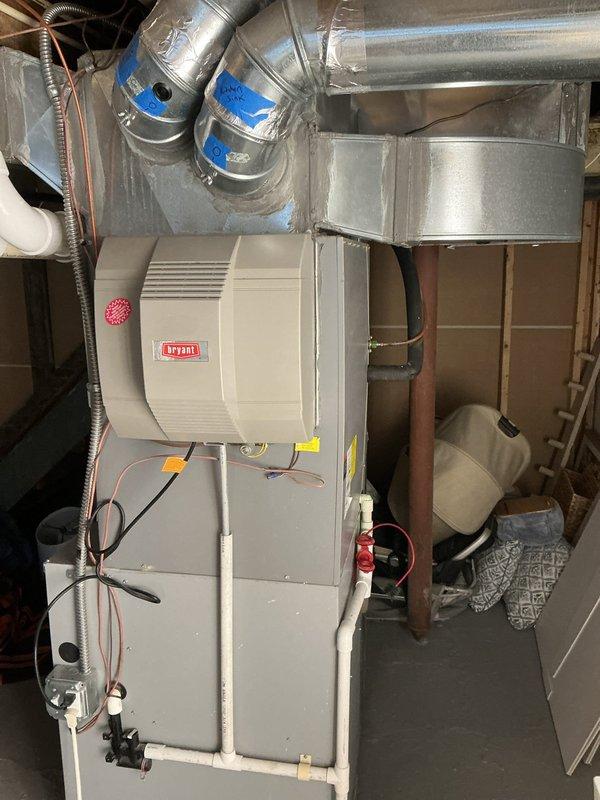 Conducted on-site assessment for adding supplemental cooling capacity to upper floors of residence. Evaluated existing Bryant furnace system with humidifier, current ductwork configuration, and available space in mechanical room for potential additional air handler or zone control equipment. Documented existing HVAC infrastructure including plenum connections, condensate drain lines, and electrical service to determine feasibility and requirements for enhanced cooling distribution to upper levels.