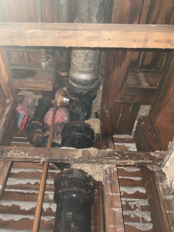 Completed diagnostic inspection of residential plumbing system to assess requirements for new washer/dryer water line installation and replacement of deteriorated galvanized piping in basement. Documented existing copper supply lines, heavily corroded galvanized vertical stack with extensive rust degradation, and current pipe routing through floor joists and structural framing to provide accurate quote for water line extension to proposed appliance location and full galvanized pipe replacement throughout basement area.