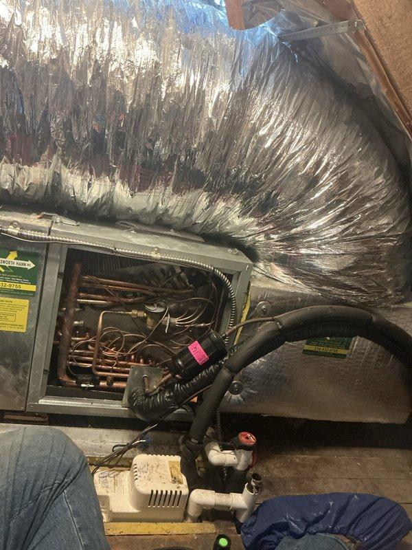 # Service Call - No Cooling and Intermittent Cycling

Responded to callback for 11-year-old AC system experiencing no cooling, intermittent cycling, and electrical issues causing light flickering. Performed comprehensive system inspection including UV leak detection and visual examination of air handler, evaporator coil assembly, and associated components. Inspected ductwork, refrigerant lines, condensate pump, and electrical connections. Documented system condition with diagnostic photography to identify root cause of cycling issues and potential electrical load problems affecting household circuits.