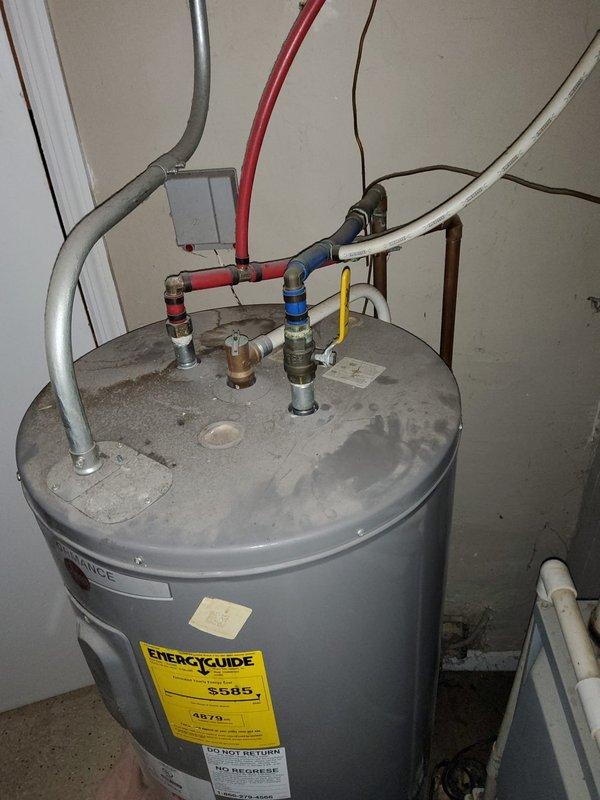 Provided no-cost estimate for water heater replacement in utility closet. During inspection, identified HVAC system requiring repair that is currently inaccessible due to existing water heater placement. Documented existing unit condition, plumbing connections including hot and cold water lines with shut-off valves, electrical junction box, and surrounding mechanical space constraints for replacement planning.