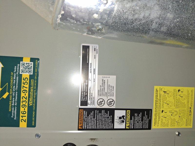 Completed routine AC tune-up on garage-mounted air conditioning system with no reported issues or concerns. Performed standard maintenance procedures including system inspection, temperature differential measurements using digital instrumentation, and verification of proper operation. Unit showed typical wear with some corrosion visible on ductwork components; all safety labels and manufacturer information confirmed intact and legible.