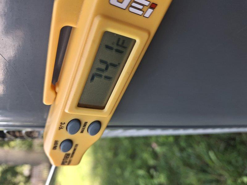 Completed routine AC tune-up on garage-mounted air conditioning system with no reported issues or concerns. Performed standard maintenance procedures including system inspection, temperature differential measurements using digital instrumentation, and verification of proper operation. Unit showed typical wear with some corrosion visible on ductwork components; all safety labels and manufacturer information confirmed intact and legible.