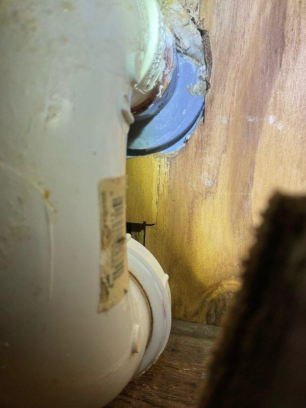 Responded to ongoing water leak issue that remained unresolved after previous service visit. Conducted thorough inspection of plumbing system in crawl space area, examining white supply piping, blue couplings, and brass fittings for source of leak. Investigation revealed significant corrosion and mineral buildup on copper piping connections entering water heater tank, with visible oxidation and turquoise-green patina indicating long-term moisture exposure. Documented extensive water staining and mineral deposits on interior tank surfaces, suggesting persistent leak at pipe penetration point with compromised sealing. Photographed corroded components and deteriorated blue insulation material around connection points to assess extent of damage and determine necessary repairs for permanent resolution of leak issue.