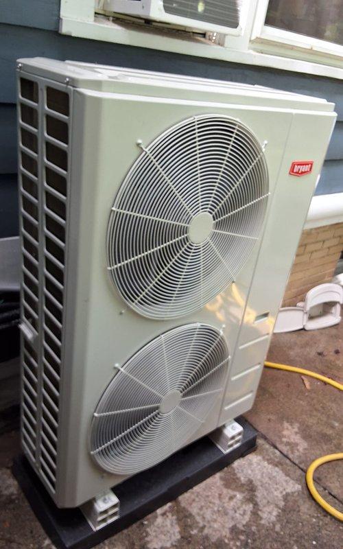Completed installation of a 5-zone Bryant ductless mini split heat pump system consisting of one 9,000 BTU high wall unit in rear left bedroom, three 12,000 BTU high wall units in master bedroom, rear right bedroom, and kitchen, plus one 12,000 BTU floor console unit in living room. Refrigerant linesets were routed through basement from outdoor condenser positioned on concrete pad at rear of home per specifications. All indoor units were mounted, electrical connections completed, system evacuated, charged, and tested for proper operation with all zones functioning correctly.