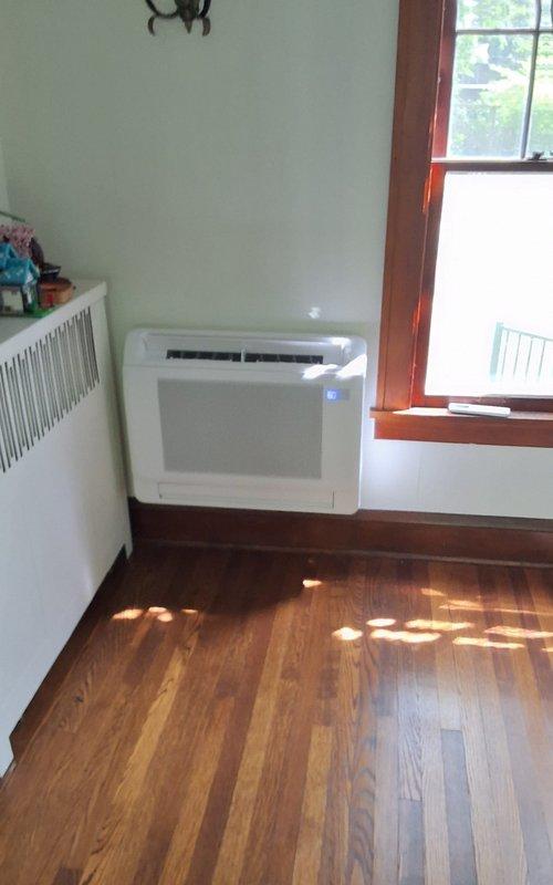 Completed installation of a 5-zone Bryant ductless mini split heat pump system consisting of one 9,000 BTU high wall unit in rear left bedroom, three 12,000 BTU high wall units in master bedroom, rear right bedroom, and kitchen, plus one 12,000 BTU floor console unit in living room. Refrigerant linesets were routed through basement from outdoor condenser positioned on concrete pad at rear of home per specifications. All indoor units were mounted, electrical connections completed, system evacuated, charged, and tested for proper operation with all zones functioning correctly.