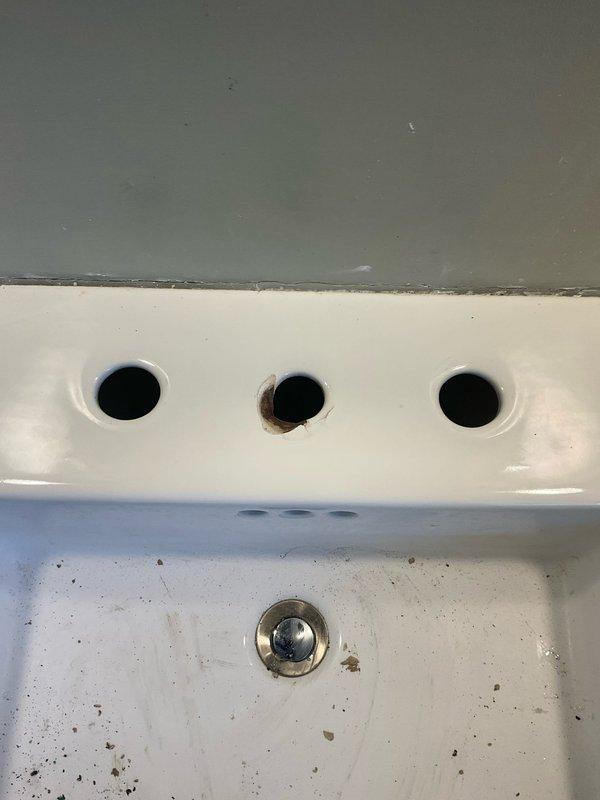 Installed a two-handle chrome widespread lavatory faucet with pop-up drain assembly on bathroom sink. Ordered and supplied necessary extensions and volume control components to complete the installation and ensure proper water flow and drainage function.