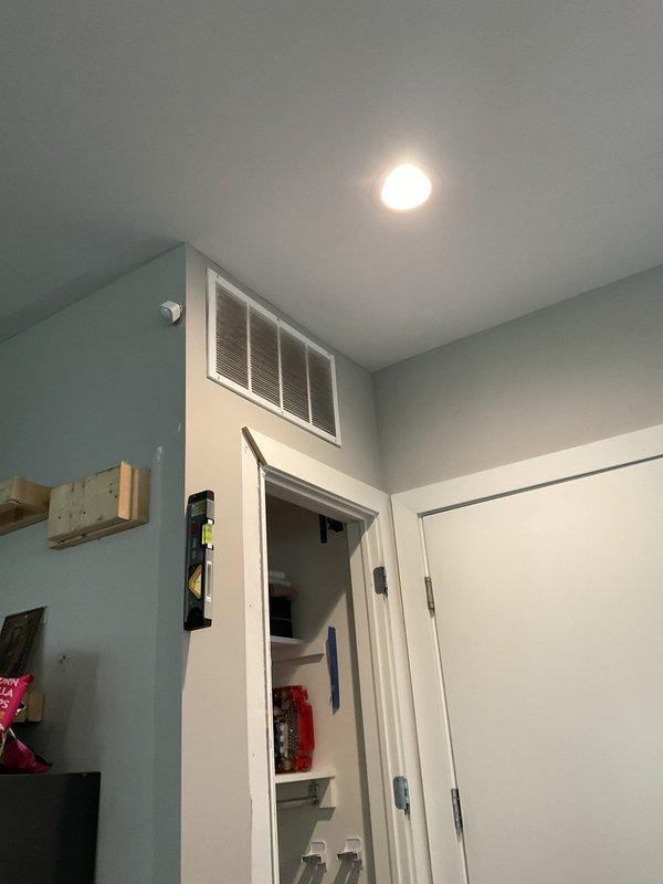 Performed descaling maintenance on a 3-year-old EcoSmart tankless water heater unit. Flushed system with descaling solution to remove mineral buildup, verified proper operation of heating elements and flow sensors, and confirmed unit returned to normal functioning with digital display reading correctly.
