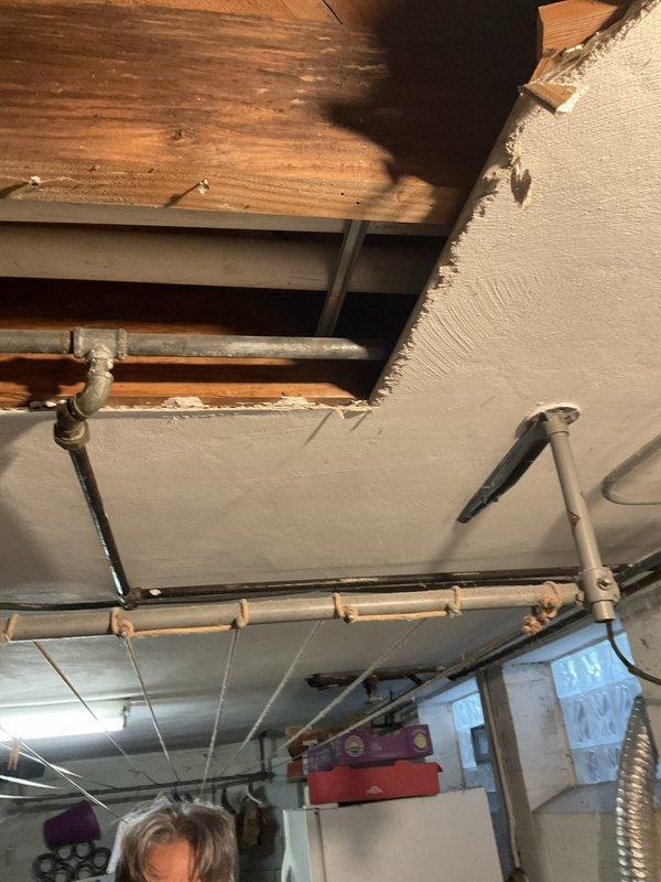 Responded to reported drilling noise from water pipes above downstairs sink in 80-year-old home. Upon arrival, inspected plumbing system and HVAC components in basement utility area near air conditioning unit. Confirmed noise ceased when air conditioning was turned off, indicating AC system rather than plumbing as source of disturbance. Examined copper water supply lines, shutoff valves, and exposed piping running along ceiling joists—all plumbing components found to be secure and functioning properly with no leaks, pressure issues, or risk of pipe burst. Inspected ceiling-mounted ductwork, flexible venting, and HVAC connections in vicinity of reported noise. Determined vibration from air conditioning operation was likely transmitting through adjacent pipes or mounting hardware, creating drilling-like sound. Advised that plumbing system posed no immediate concerns but recommended HVAC specialist evaluate air conditioning unit for loose components, mounting issues, or mechanical problem