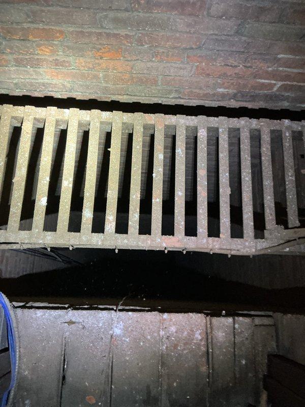 Conducted site evaluation for heating and cooling system options including potential rooftop unit and mini-split configurations. Assessed existing ventilation infrastructure and interior space conditions in attic area with exposed brick walls and slanted ceiling to determine optimal equipment placement and installation requirements for proposed HVAC solutions.