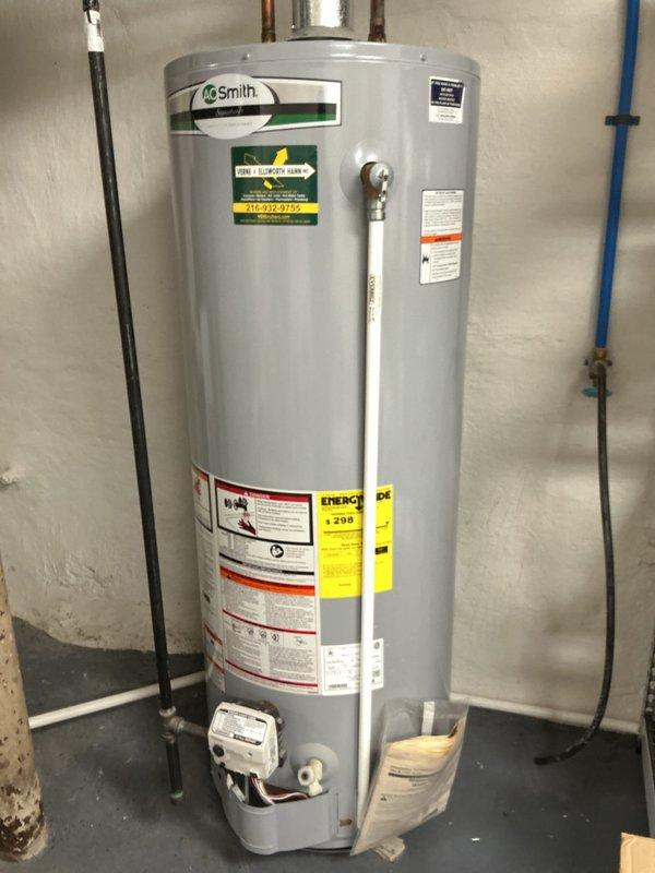 Responded to cross-trade request for tankless water heater estimate and HVAC system balancing assessment. Evaluated existing A.O. Smith tank-style water heater installation in basement utility area, documenting current plumbing configuration including copper supply lines, gas connections with flexible yellow CSST line, and electrical service. Assessed reported temperature inconsistencies throughout multi-level residence with cold conditions on lower level and excessive heat upstairs, indicating inadequate system balancing and lack of airflow control options due to single-speed blower operation.