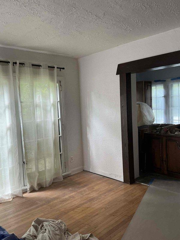 Conducted follow-up site assessment for HVAC system replacement in residential property. Documented existing interior conditions and evaluated installation access points, including assessment of fireplace opening that showed evidence of deterioration, moisture damage, and accumulated debris requiring consideration for equipment placement and ventilation routing.