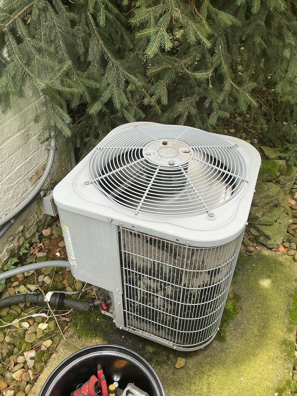 Completed routine maintenance tune-up on 6-year-old residential air conditioning system utilizing R410A refrigerant. Unit exhibited minor outdoor debris accumulation and weathering consistent with age, but overall operational condition was satisfactory. Performed standard preventive maintenance procedures including inspection of condenser coil fins, fan guard assembly, and electrical specifications verification on outdoor condensing unit.