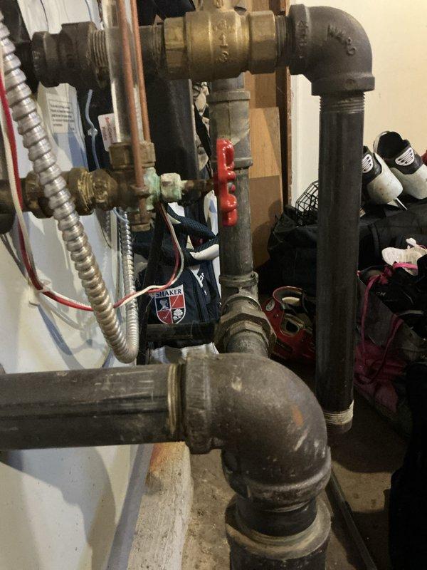 Performed comprehensive tune-up and routine maintenance on 10-year-old steam boiler and 2-year-old water heater located in basement. Inspected all piping connections, brass fittings, and ball valves for leaks and proper operation. Verified burner assembly operation with visual flame inspection showing proper combustion with characteristic blue flames across all burner sections. Tested safety controls, examined heat exchanger components, and confirmed all electrical connections were secure. System operating within normal parameters upon completion.