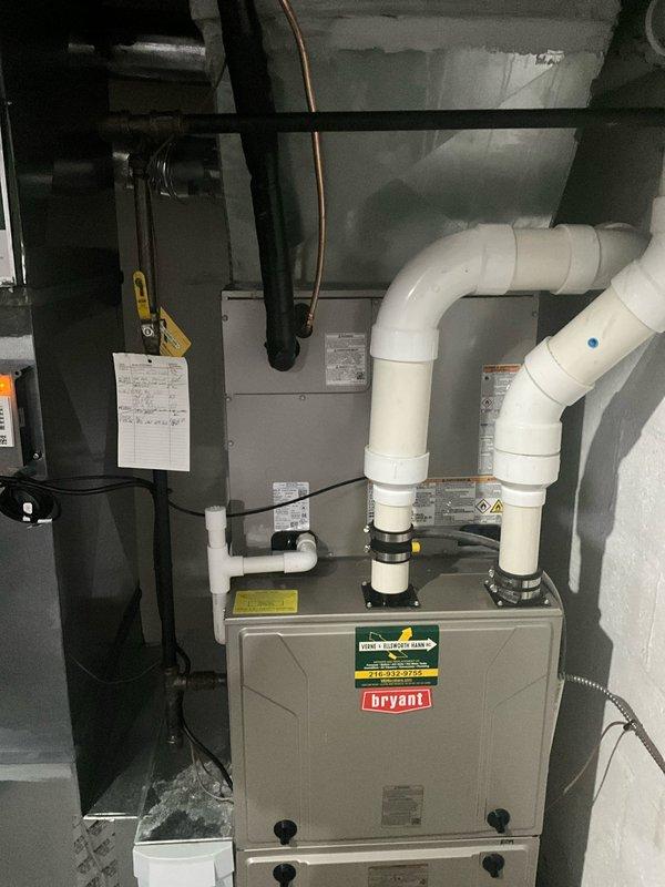 Completed full HVAC system upgrade including removal of existing equipment and installation of new Bryant air conditioning condenser unit and evaporator coil. Mounted outdoor condenser on prepared gravel pad with proper clearances and connected refrigerant lines to indoor coil positioned above existing Bryant furnace. Installed new PVC condensate drain lines with appropriate pitch and routing through utility space. Ran electrical disconnect and line set through exterior wall penetration with proper sealing. Reused existing thermostat and verified communication with new equipment. Evacuated refrigerant lines to manufacturer specifications, charged system to nameplate requirements, and performed full operational testing of cooling cycle. Verified proper airflow, temperature split, and system pressures across all operating conditions.