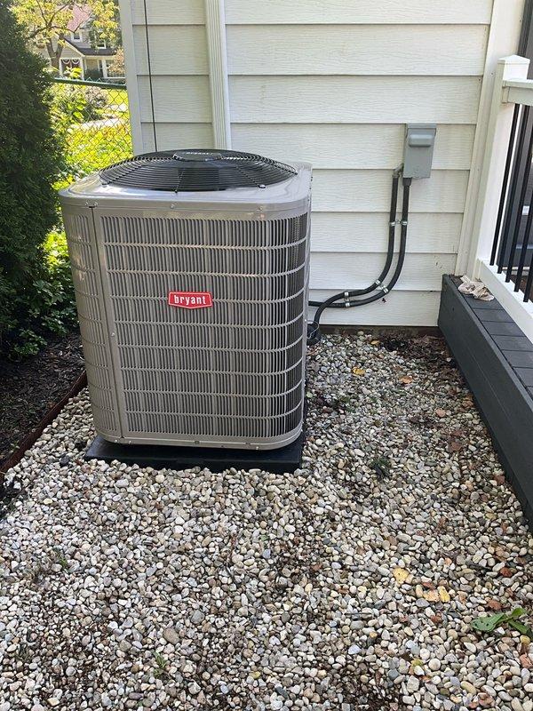 Completed full HVAC system upgrade including removal of existing equipment and installation of new Bryant air conditioning condenser unit and evaporator coil. Mounted outdoor condenser on prepared gravel pad with proper clearances and connected refrigerant lines to indoor coil positioned above existing Bryant furnace. Installed new PVC condensate drain lines with appropriate pitch and routing through utility space. Ran electrical disconnect and line set through exterior wall penetration with proper sealing. Reused existing thermostat and verified communication with new equipment. Evacuated refrigerant lines to manufacturer specifications, charged system to nameplate requirements, and performed full operational testing of cooling cycle. Verified proper airflow, temperature split, and system pressures across all operating conditions.