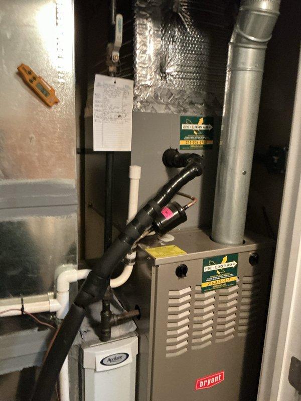 Completed preventative maintenance on 5-year-old Bryant cooling system. Inspected evaporator coil and noted dust accumulation on aluminum fins; verified furnace and connected equipment operational. System components including Aprilaire humidifier and ductwork inspected and documented with photos for maintenance records.