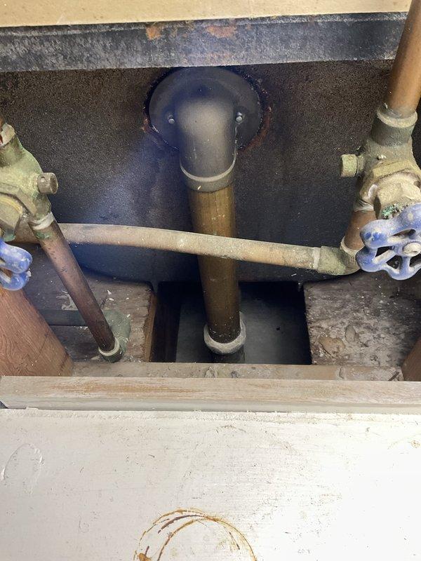 Responded to ceiling leak in basement bathroom originating from upstairs plumbing. Upon inspection, identified water intrusion affecting ceiling near HVAC vent with visible wetness and minor damage to finished surface. Accessed crawl space and inspected supply line plumbing infrastructure, including brass standpipes and shut-off valves serving both bathroom fixtures. Verified integrity of copper supply lines and valve connections. Documented existing plumbing configuration and insulated areas showing moisture penetration patterns. Recommended monitoring for additional leakage and further investigation of upstairs bathroom fixture connections to determine exact source of water intrusion.
