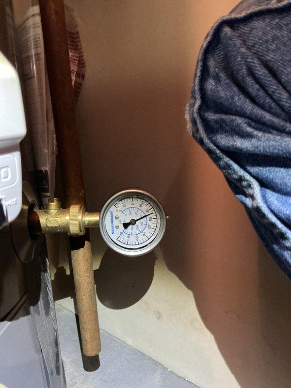 Responded to reported hot water tank leak and conducted diagnostic assessment. Upon inspection, identified frost buildup on copper supply line indicating temperature differential issue rather than active leak from tank itself. Monitored system through heating cycle to verify leak source and inspected all connections, fittings, and pressure relief valve. Installed pressure gauge on system to verify proper operating pressure and rule out pressure-related concerns. 

Performed complimentary whole-home plumbing assessment as requested, including inspection of all visible supply and drain lines, fixtures, and connections throughout property. Investigated upstairs shower plumbing to address reported knocking in pipes, identifying potential water hammer condition requiring further evaluation of air chambers or possible installation of water hammer arrestors. Documented all findings with photographic evidence showing frosted copper piping and pressure monitoring equipment installation. Secured
