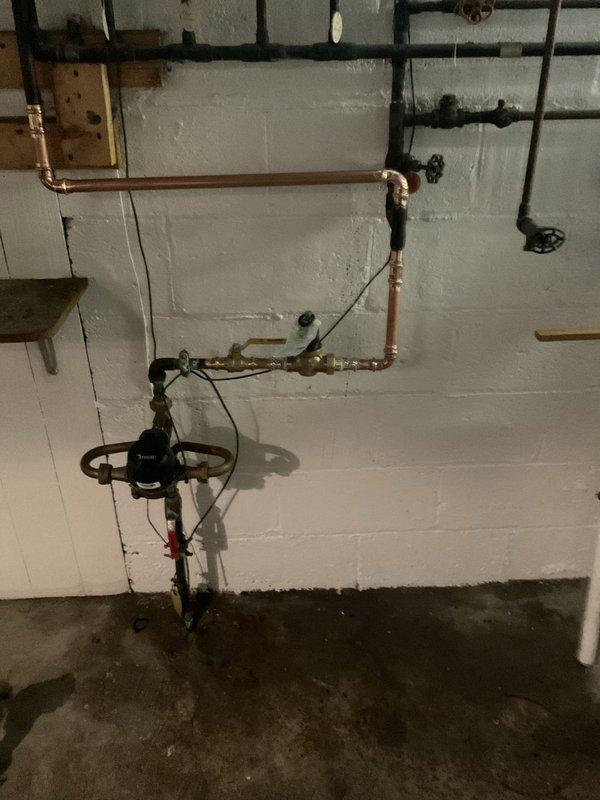 Installed a new three-quarter inch water pressure regulator with integrated expansion tank on the main water line to regulate incoming water pressure and protect the plumbing system from thermal expansion. Added a three-quarter inch ball valve for isolation capability, allowing future maintenance or repairs without shutting down the entire water supply. All components were mounted to the basement utility wall near the existing water meter and distribution manifold, with proper support brackets and connections to the copper supply lines.