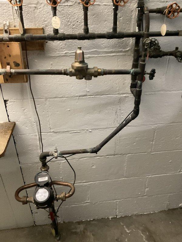 Installed a new three-quarter inch water pressure regulator with integrated expansion tank on the main water line to regulate incoming water pressure and protect the plumbing system from thermal expansion. Added a three-quarter inch ball valve for isolation capability, allowing future maintenance or repairs without shutting down the entire water supply. All components were mounted to the basement utility wall near the existing water meter and distribution manifold, with proper support brackets and connections to the copper supply lines.