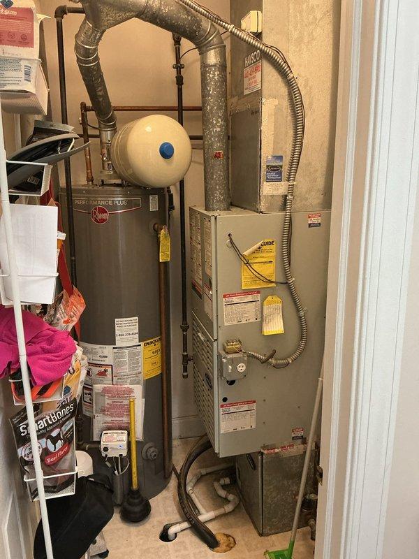 Conducted comprehensive assessment of existing HVAC system for replacement estimate. Evaluated aging furnace and air conditioning equipment showing visible signs of wear, dust accumulation on ductwork, and overall system deterioration. Documented current installation configuration including furnace unit, water heater, ductwork layout, and mechanical room conditions to provide accurate replacement recommendations and equipment specifications.
