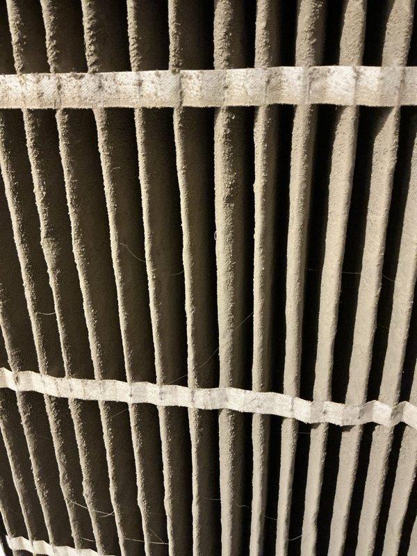 Responded to service call for frozen evaporator coil on 17-year-old air conditioning unit located in basement. Upon arrival, customer had already turned off system and allowed coil to thaw and dry per initial troubleshooting. Inspected evaporator coil assembly and confirmed previous freezing condition. Examined air filter and found significant dust and debris accumulation restricting airflow, which is a primary cause of coil freezing. Inspected return air grille and noted substantial dust buildup and cobwebs on louvers and surrounding areas, further contributing to reduced system airflow. Documented condition of filtration system and ventilation components with photographs showing extent of contamination. Customer indicated concern about potential refrigerant charge requirement; however, restricted airflow from dirty filter and return grille is likely root cause of freezing issue rather than low refrigerant. Advised customer that proper airflow must be restored before any refrigerant a