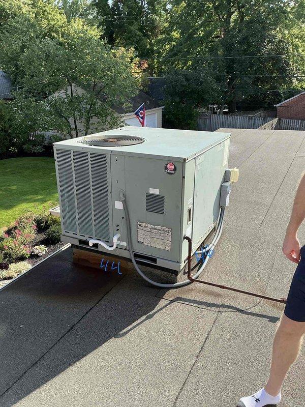 Conducted comprehensive assessment of rooftop package HVAC unit for replacement estimate. Unit located on flat residential roof with easy access, positioned outside window with adequate clearance for equipment removal and installation. Documented existing system configuration including refrigerant line routing, electrical conduit connections, and current mounting platform setup. Photographed unit specifications, manufacturer labels, and surrounding rooftop conditions to determine proper replacement equipment sizing and installation requirements. Evaluated roof membrane integrity around unit base and confirmed structural support adequacy for new equipment installation.