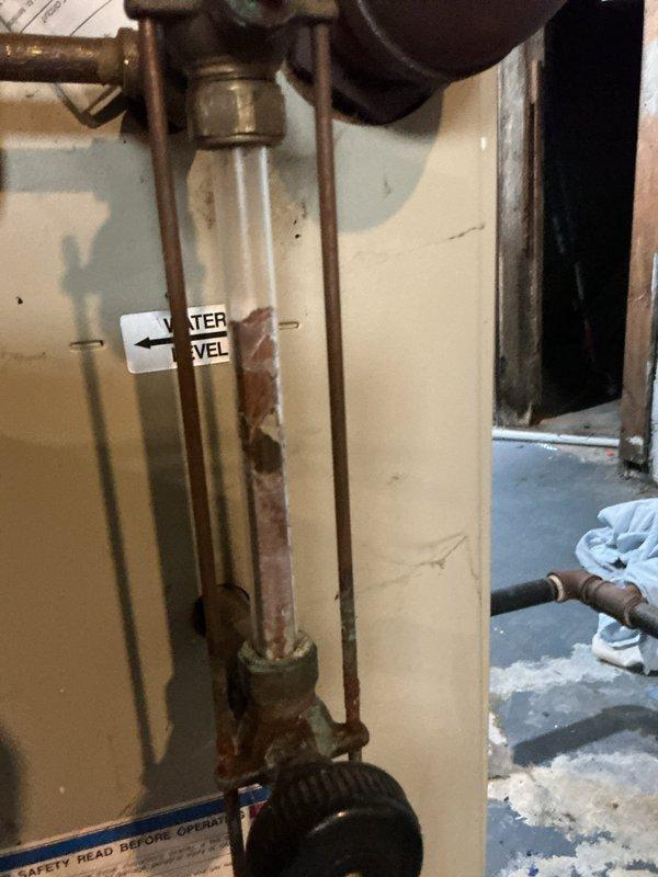Responded to no-heat call for boiler system. Upon arrival, inspected heating system and thermostat operation per tenant report of non-functioning boiler. Verified thermostat battery condition and tested system controls including Honeywell zone valve and boiler firing sequence. Confirmed proper water level in boiler sight glass and inspected all associated copper piping connections for integrity. System restored to normal operation with heat confirmed at thermostat.