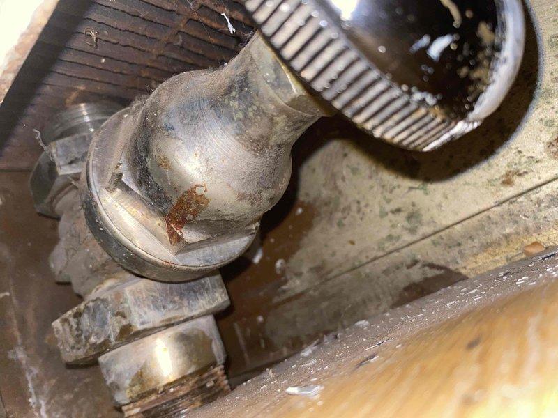 Responded to service call for steam radiator evaluation. Upon inspection, found significant corrosion and rust deterioration on radiator piping connections and elbow fittings in mechanical area. Documented existing condition showing surface oxidation, discoloration, and compromised metal integrity on connection points. Inspected associated heating system components including blower assembly and heat exchanger coils. Evaluated wall-mounted radiator grille and ventilation system in living space. Photographed deteriorated components and overall system condition for assessment and repair recommendations.