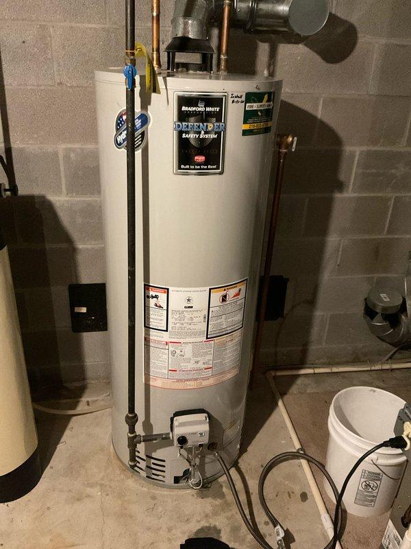 Responded to service call for Bradford White natural gas water heater experiencing intermittent shutdowns. Upon arrival, performed comprehensive diagnostic inspection of the unit, including examination of the burner assembly, thermocouple, gas control valve, and venting system. Verified proper gas supply and pressure to the appliance. Inspected the Defender Safety System components and tested thermal cutoff switch functionality. Checked all electrical connections and pilot assembly for proper operation. Documented equipment specifications including 50,000 BTU/HR input capacity and current installation configuration with copper supply lines and shutoff valves. Unit showed no active fault conditions during service visit. Provided operational guidance and recommendations for monitoring system performance.