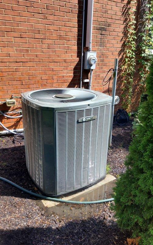 Completed AC tune-up on five-year-old residential condensing unit. System operating properly at time of service. Performed standard maintenance procedures including inspection of electrical components, capacitor, and condenser coil. Unit exterior shows normal wear for age, with internal electrical components displaying moderate corrosion and debris accumulation requiring monitoring for future service needs.