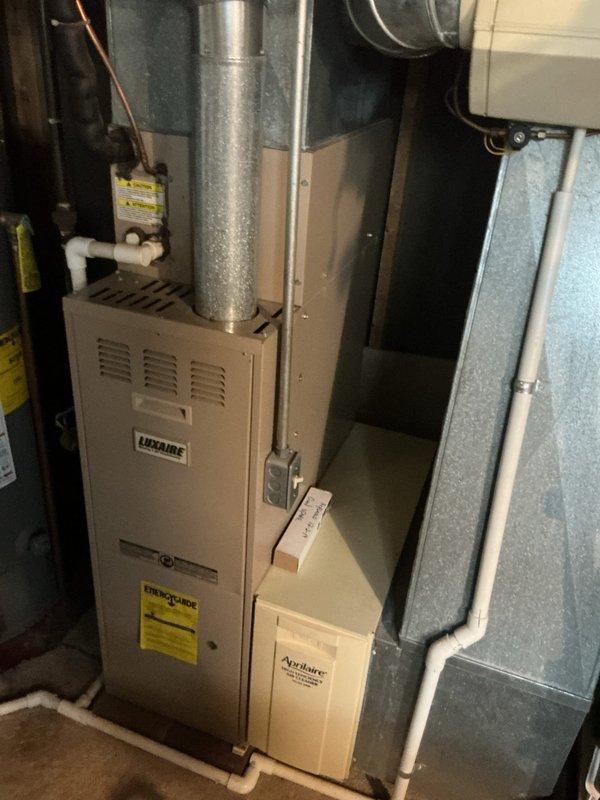 Responded to no-cooling complaint on 15-year-old residential air conditioning system affecting entire home. Performed diagnostic evaluation of Luxaire HVAC system, model G1UAD05014B, including inspection of outdoor condensing unit, indoor air handler, ductwork, and associated components. Documented system specifications and current operating condition with photographic evidence for customer records and future reference.