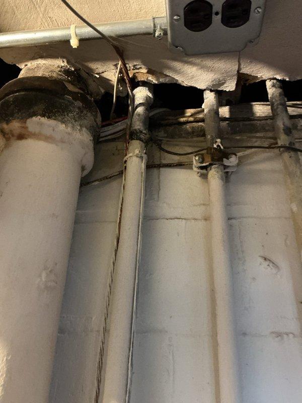 Responded to service call for minor leak on plumbing supply line. Upon inspection, identified leak location on vertical piping system in utility area with exposed infrastructure. Documented existing conditions of multi-pipe configuration with shut-off valves and connection points. Provided comprehensive estimate for leak repair including necessary materials and labor to address the issue and restore system integrity.