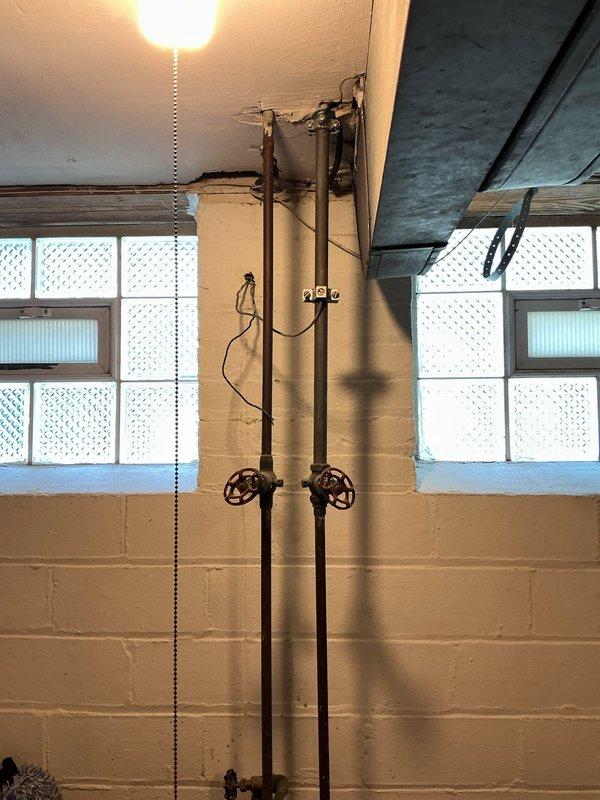 Responded to service call for minor leak on plumbing supply line. Upon inspection, identified leak location on vertical piping system in utility area with exposed infrastructure. Documented existing conditions of multi-pipe configuration with shut-off valves and connection points. Provided comprehensive estimate for leak repair including necessary materials and labor to address the issue and restore system integrity.