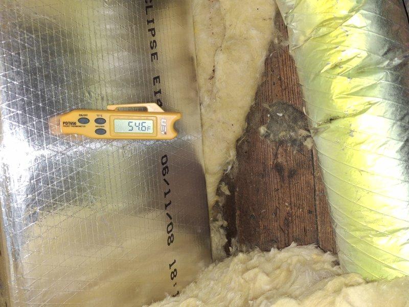 Responded to callback for 15-year-old air conditioning system with ongoing no-cool condition after three previous service visits. Performed comprehensive system diagnostics including temperature differential measurements across the air handler, which revealed supply air temperature of 54.5°F and return air temperature of 75.5°F, indicating inadequate cooling performance. Inspected evaporator coil access area in attic space and documented insulation conditions around air handler unit. Based on age of equipment, frequency of recent service calls, and performance measurements indicating system inefficiency, recommended replacement of aging air conditioning system to resolve recurring issues and restore reliable cooling operation.