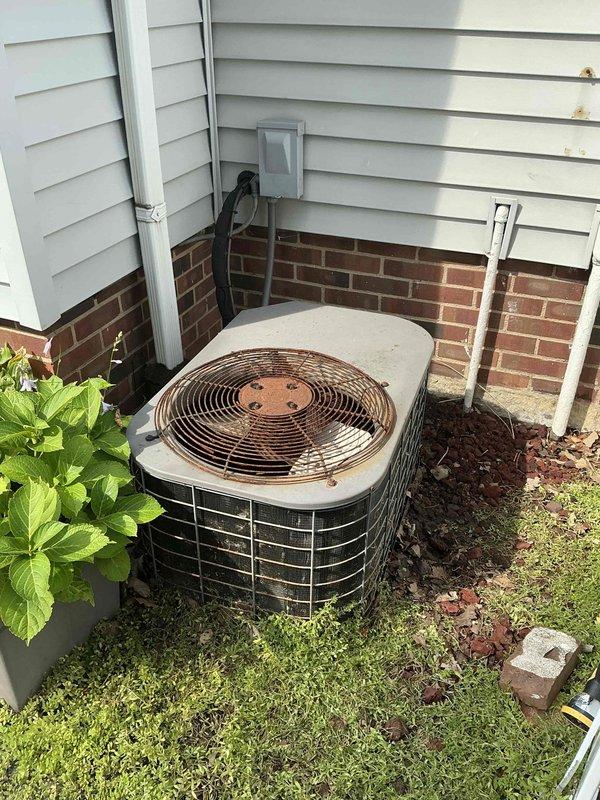 Responded to service call for air conditioning system blowing warm air and not cooling entire residence. Upon inspection, evaluated 15-year-old outdoor condensing unit showing visible signs of age, corrosion on fan guard, and weathering on exterior surfaces. Assessed indoor air handler unit located in basement with connected ductwork and determined system had reached end of serviceable life. Provided comprehensive replacement estimate for complete HVAC system due to age and condition of existing equipment.