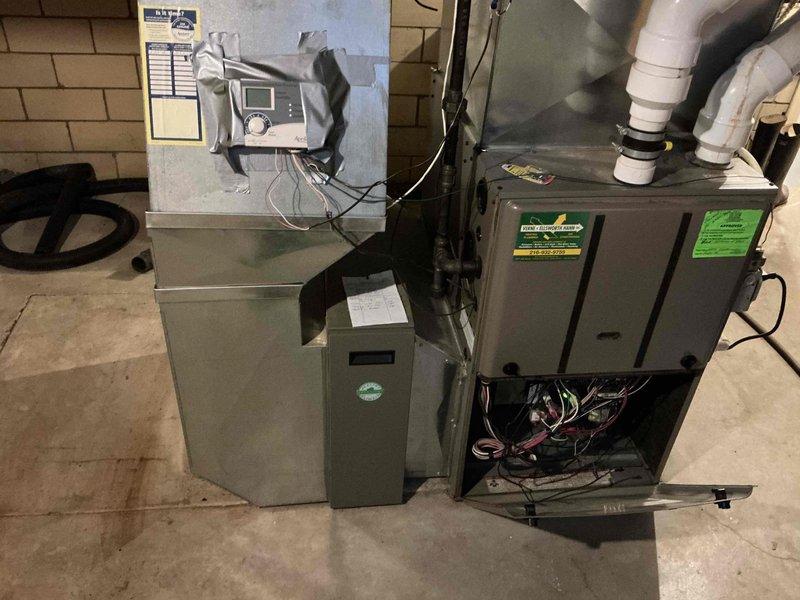 Conducted comprehensive assessment of existing HVAC system in basement utility area for equipment replacement estimate. Documented current furnace installation, including unit configuration, existing ductwork connections, PVC condensate drainage system, and electrical wiring setup. Evaluated humidifier integration, wall-mounted control systems, and overall equipment layout to determine replacement specifications and installation requirements.