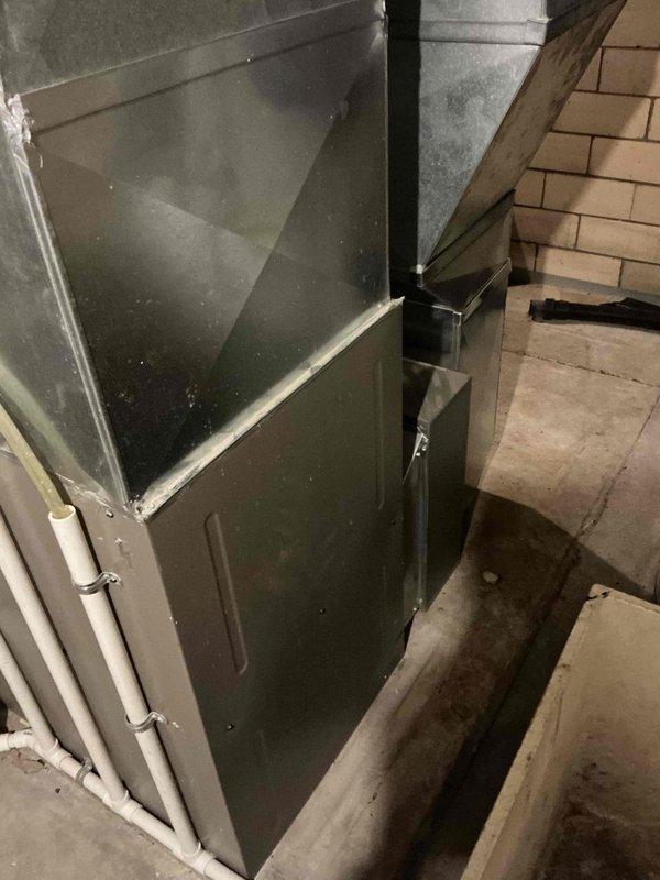 Conducted comprehensive assessment of existing HVAC system in basement utility area for equipment replacement estimate. Documented current furnace installation, including unit configuration, existing ductwork connections, PVC condensate drainage system, and electrical wiring setup. Evaluated humidifier integration, wall-mounted control systems, and overall equipment layout to determine replacement specifications and installation requirements.