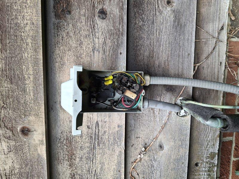Responded to no cooling call where air conditioning system was completely inoperative. Upon arrival, inspected outdoor condensing unit and found unit not receiving power. Traced electrical supply to disconnect box mounted on fence and discovered failed wire connections with burnt wire nuts indicating previous overheating and electrical failure. Removed damaged connections, stripped wire ends back to clean copper, and installed new wire nuts with proper torque to ensure solid electrical contact. Verified proper voltage at disconnect and restored power to condensing unit. Tested system operation and confirmed compressor and condenser fan motor energized properly with normal amperage draw on all components. System cooling normally upon departure.