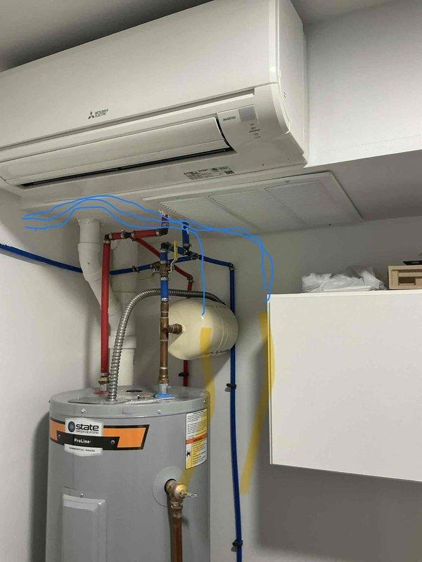 Responded to ongoing leak issue with third-floor Mitsubishi mini-split unit that has persisted since installation. Inspected dual mini-split system mounted above water heater in mechanical room, checked condensate drainage system, refrigerant lines, and mounting integrity to identify source of water leakage. Documented system configuration and current conditions with photos for ongoing resolution of this recurring concern.