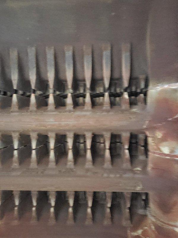 Performed annual boiler maintenance and tune-up on basement-installed unit of unknown age. System was operating normally with no reported issues at time of service. Inspection revealed significant dust and debris accumulation on heat exchanger fins and internal components, which was documented photographically for service records.