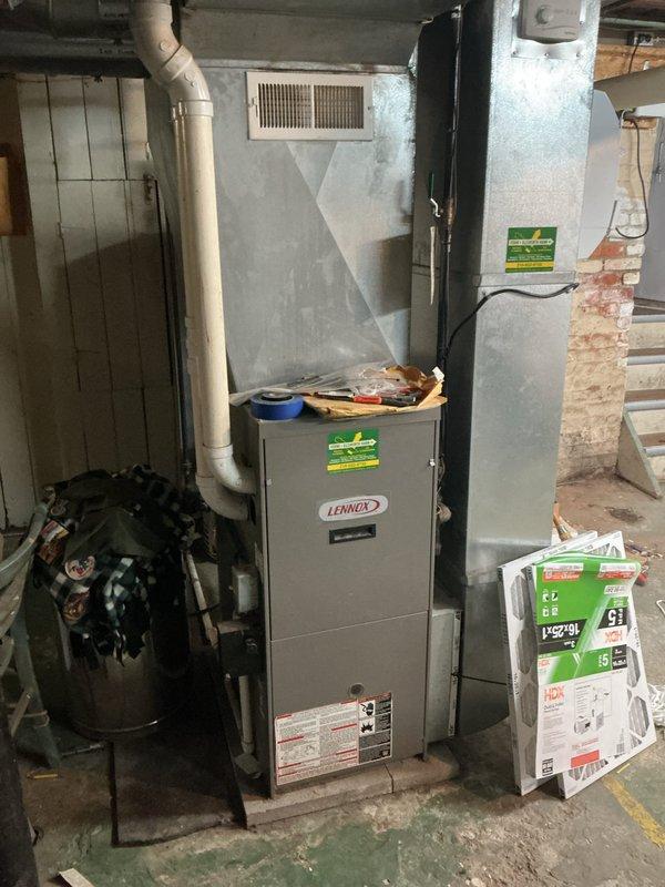 Conducted comprehensive on-site assessment of existing 1997 residential HVAC system for replacement estimate. Evaluated aging Lennox furnace unit in basement utility area and outdoor condenser unit, both showing significant wear and deterioration consistent with 27-year-old equipment. Documented current system configuration including ductwork connections, air return placement, and electrical/mechanical components. Photographed outdoor condenser unit displaying visible rust, weathering, and compromised performance due to neglected maintenance and vegetation overgrowth impeding proper airflow. Provided detailed equipment evaluation and replacement recommendations for complete system upgrade to restore efficient heating and cooling operation.