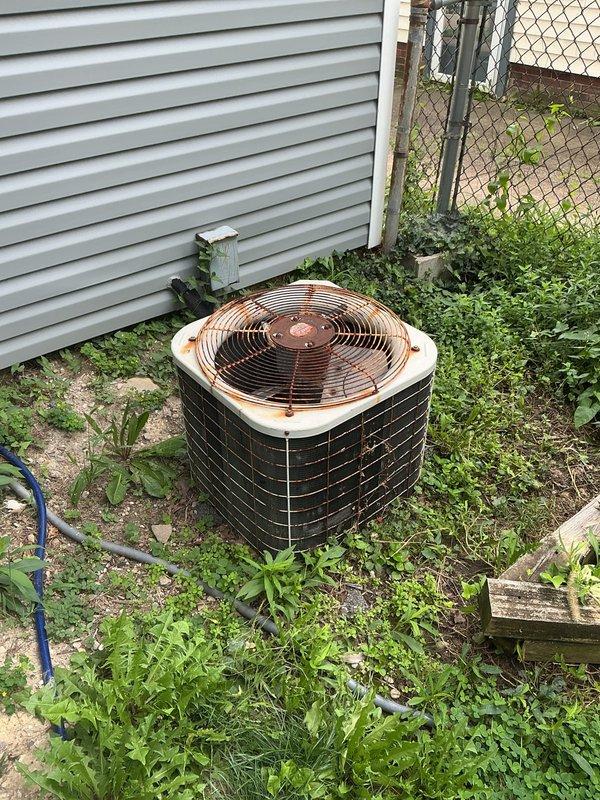Conducted comprehensive on-site assessment of existing 1997 residential HVAC system for replacement estimate. Evaluated aging Lennox furnace unit in basement utility area and outdoor condenser unit, both showing significant wear and deterioration consistent with 27-year-old equipment. Documented current system configuration including ductwork connections, air return placement, and electrical/mechanical components. Photographed outdoor condenser unit displaying visible rust, weathering, and compromised performance due to neglected maintenance and vegetation overgrowth impeding proper airflow. Provided detailed equipment evaluation and replacement recommendations for complete system upgrade to restore efficient heating and cooling operation.