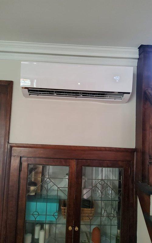 Responded to service call for noisy mini-split air conditioning unit. Upon inspection, identified malfunctioning condensate pump as source of operational noise. Removed defective blue condensate pump assembly with dual drainage tubes and brass fittings, replaced with new unit, and verified proper drainage function. Tested indoor wall-mounted evaporator unit for normal operation, confirmed quiet performance and proper temperature display functionality.